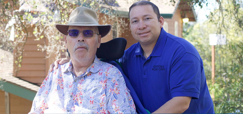 Man in Wheelchair With Caregiver